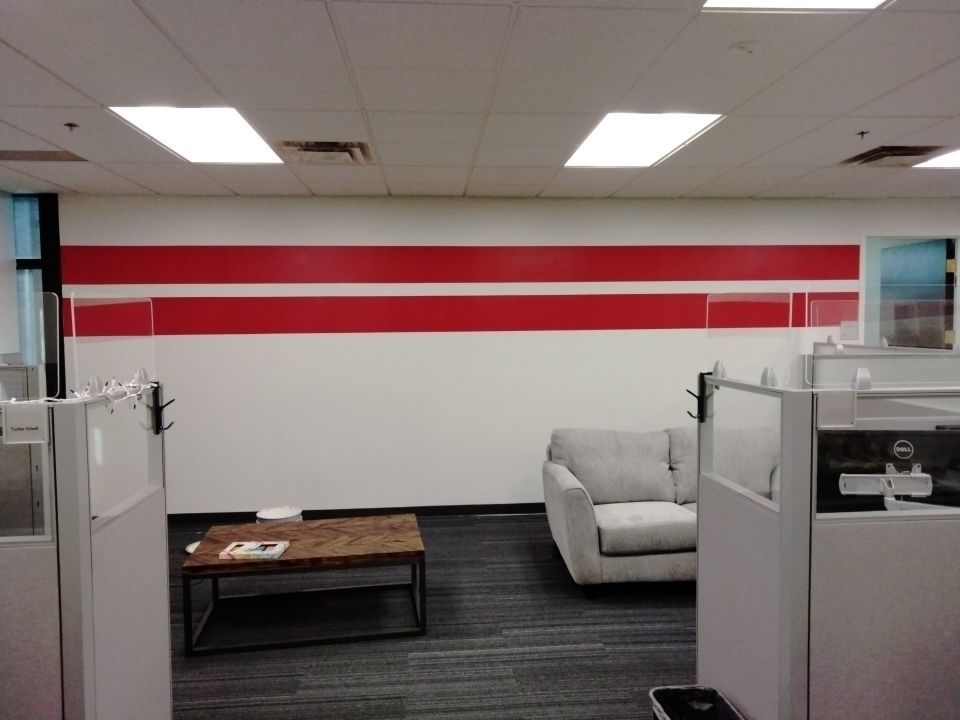 An office space with white sofa and cubicles - Commercial Painters in Lawrence, KS