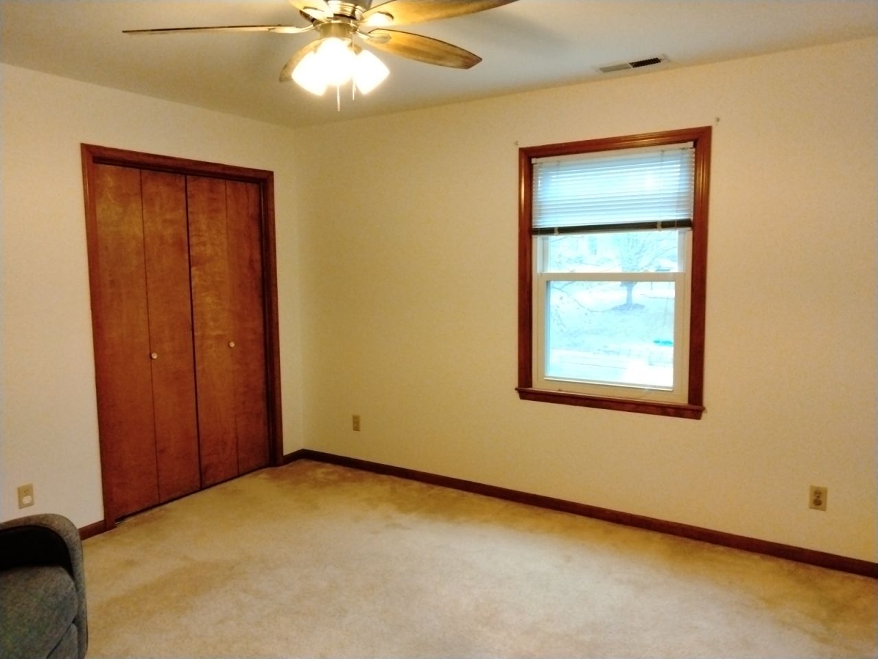 An empty room with a window and ceiling fan- Lawrence, KS interior house painters