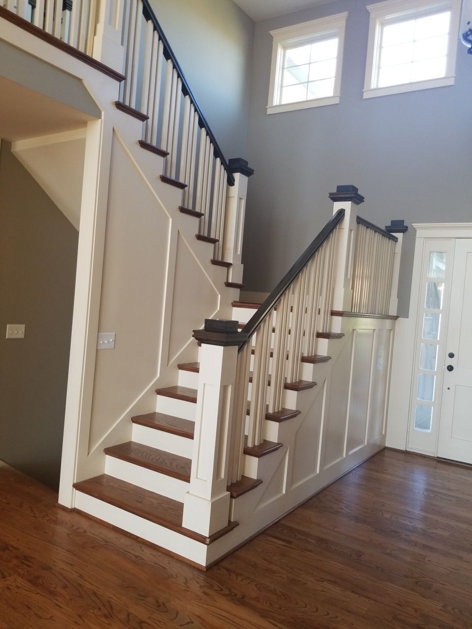 A white and wooden design staircase of a house- house painters in Leawood, KS