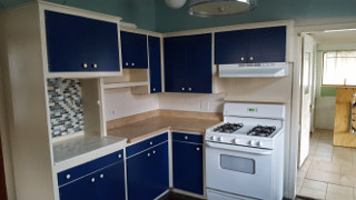 A laundry room with blue painted cabinets- Lawrence, KS Cabinet Painters