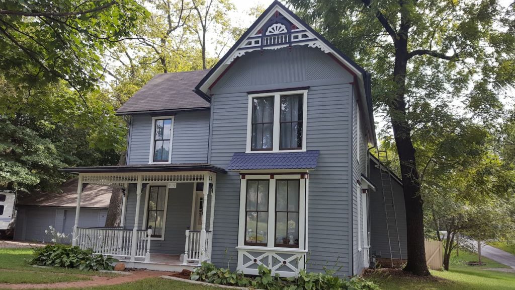 A gray painted two storey house- Exterior House Painting Services in Lawrence, KS